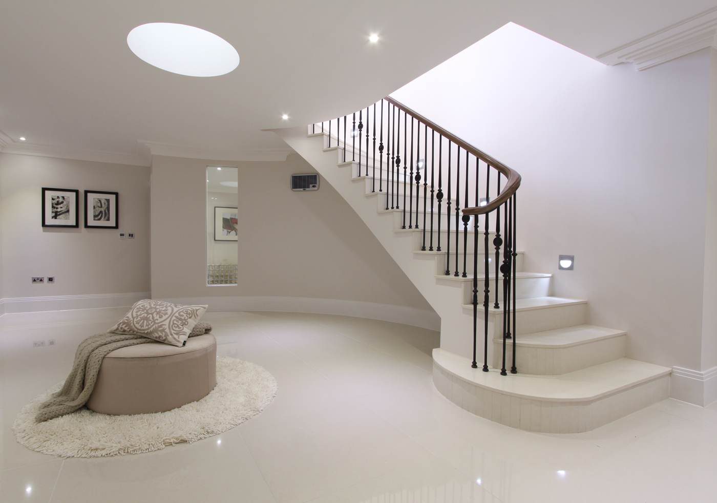 Curved staircase with iron balustrade